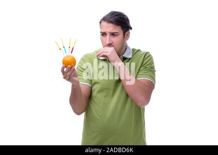 Young man in GMO fruits and vegetables concept Stock Photo