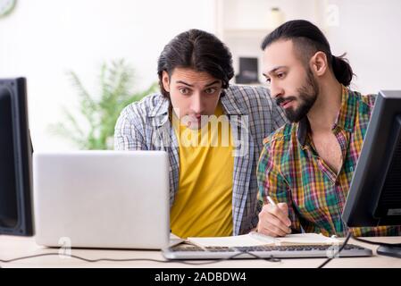 Two it specialists working in the office Stock Photo