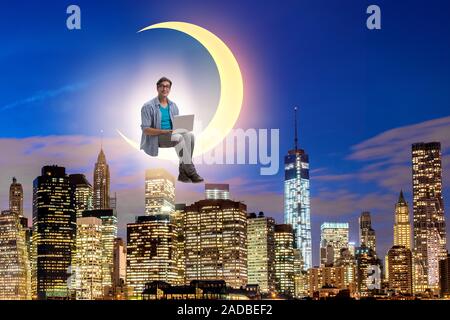 Student working on laptop on the moon crescent Stock Photo