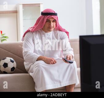 Arab Businessman watching tv at home Stock Photo