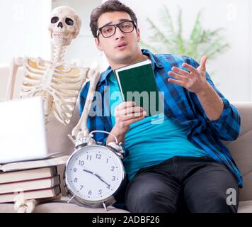 Student studying with skeleton preparing for exams Stock Photo