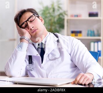Young doctor sitting in the office Stock Photo