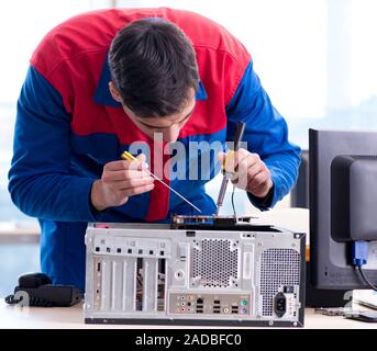 Computer repairman specialist repairing computer desktop Stock Photo