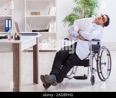 The doctor resting on wheelchair in hospital after night shift Stock Photo