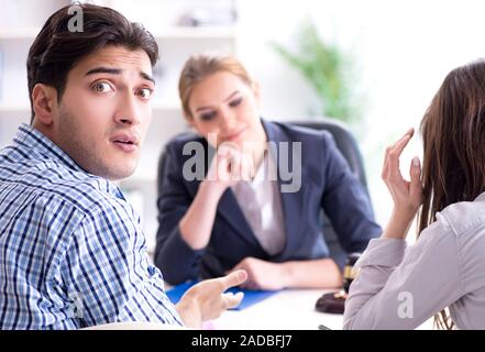 Young family filing divorce papers with lawyer Stock Photo