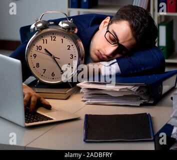 The Businessman falling asleep during long hours in office Stock Photo
