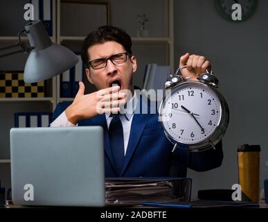 Businessman falling asleep during long hours in office Stock Photo