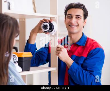 Client getting securty camera installed at home by contractor Stock Photo