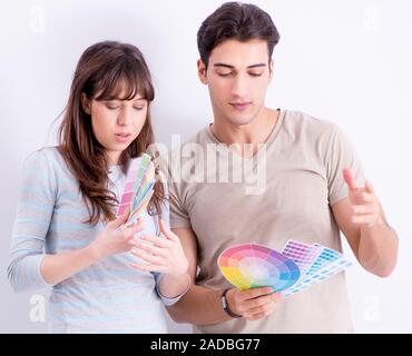 The young family doing renovation at home - painting walls Stock Photo