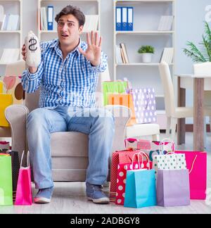 Young man after excessive shopping at home Stock Photo