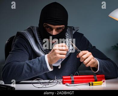 Terrorist bomber preparing dynamite bomb Stock Photo