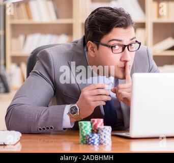 Businessman gambling playing cards at work Stock Photo