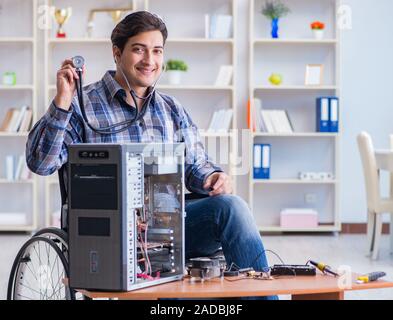 Computer repairman on wheelchair working Stock Photo