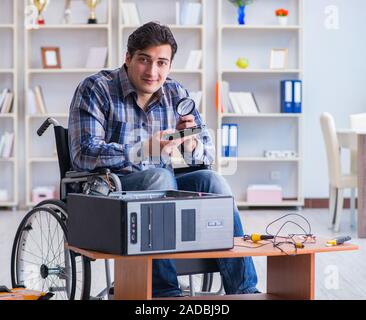 Computer repairman on wheelchair working Stock Photo