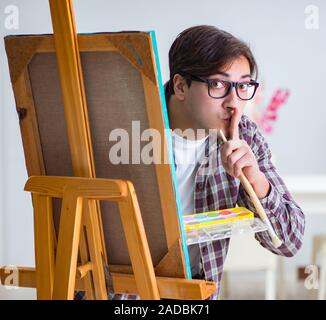 The young male artist drawing pictures in bright studio Stock Photo - Alamy