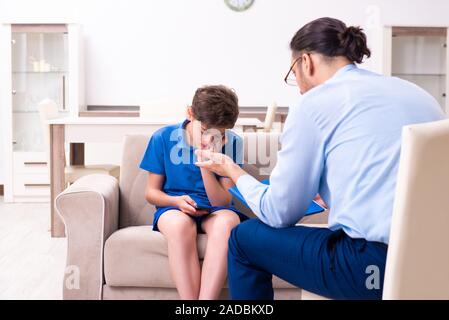 Internet addicted boy visiting male doctor Stock Photo