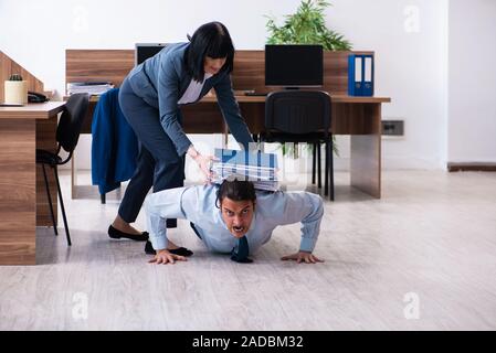 Male employee doing sport exercises in the office Stock Photo