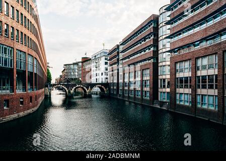 Cityscape of Hamburg in Bleichenfleet canal at dusk. Germany