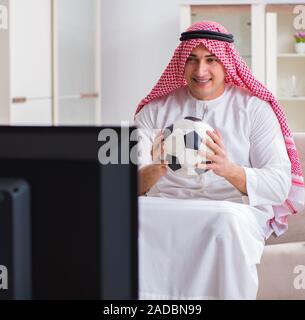 Arab Businessman watching tv at home Stock Photo