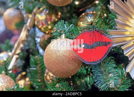 Christmas decoration in the form of red lips on a Christmas tree. Stock Photo
