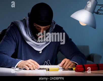 Terrorist bomber preparing dynamite bomb Stock Photo