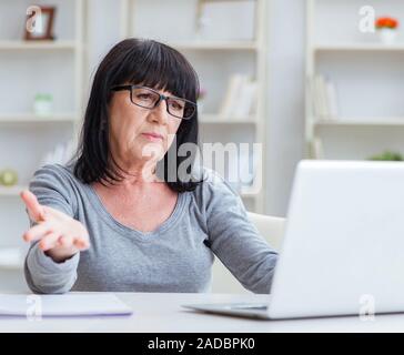 Senior woman struggling at computer Stock Photo