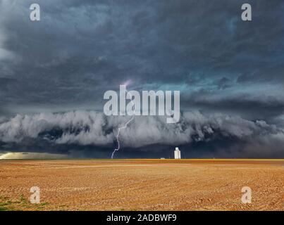 Lightning strike over wheat field. Time-exposure image of a lightning strike during a large thunderstorm over a wheat field after the crop has been ha Stock Photo