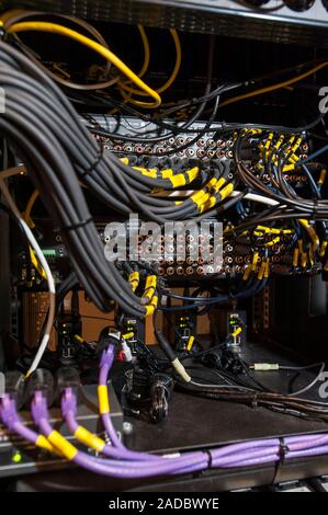 Computer server cables. A server is a computer that provides a service to other computers connected to it through a network. Servers might host websit Stock Photo