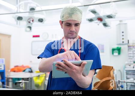 Doctor using tablet computer. Doctor using a tablet computer while at work in a hospital. Stock Photo