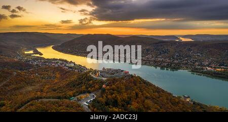 Visegrad, Hungary - Aerial panoramic drone view of the beautiful high castle of Visegrad and Salamon tower with autumn foliage and trees. Dunakanyar a Stock Photo