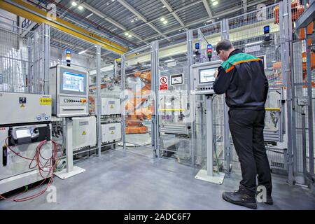 Mini car factory. Worker in the robots control area of the Mini production line at BMW's Plant Oxford site, Cowley, England, UK. This plant runs for 2 Stock Photo