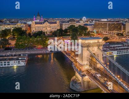 Budapest, Hungary - Aerial view of Szechenyi Chain Bridge with St. Stephen's Basilica, ferris wheel and cruise ships at blue hour on a nice summer eve Stock Photo