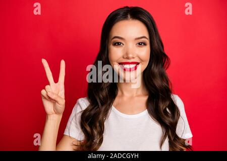 Close-up portrait of her she nice-looking attractive pretty charming glamorous lovely cheerful cheery wavy-haired girl showing v-sign isolated over Stock Photo