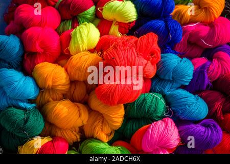 Balls of wool in different colors for sale at the weekly market Stock Photo