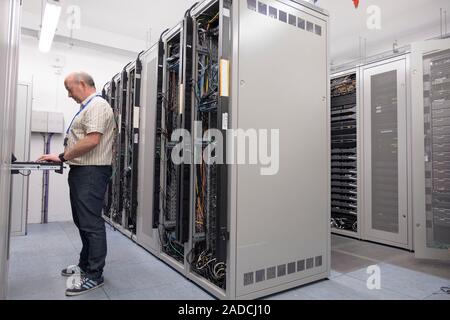 Technician checking servers in a data centre. Photographed at the University of Dundee, Scotland, UK. Stock Photo