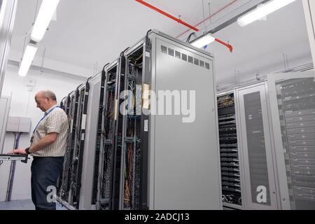 Technician checking servers in a data centre. Photographed at the University of Dundee, Scotland, UK. Stock Photo