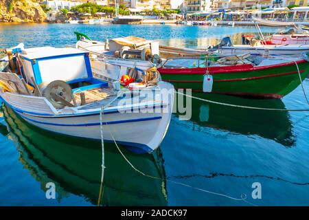 Fishing boats on the Voulismeni lake in Agios Nikolaos, Crete island, Greece. Image Stock Photo