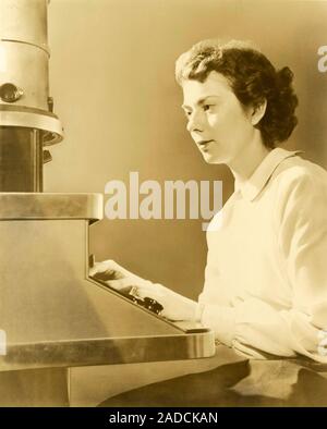 Elaine Zworykin (1926-2011), American mineralogist, being trained to operate an electron microscope. Zworykin was working for the U.S. Geological Surv Stock Photo