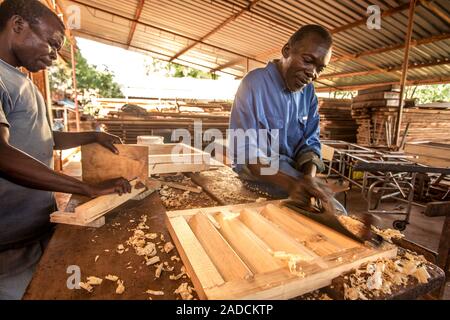 Carpentry work. Wood-working tools being used by carpenters to produce wooden goods. Photographed in Lacor, Gulu, Uganda. Stock Photo