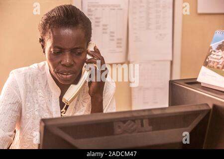 Hospital administrator working at a computer. Photographed in St Mary's Hospital, Lacor, Gulu, Uganda. Stock Photo