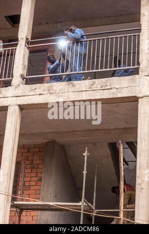 Construction workers welding railings on a building site. Photographed in Lacor, Gulu, Uganda. Stock Photo