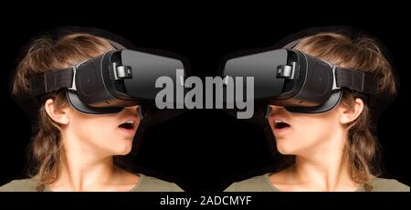 Twinned virtual reality headsets. Virtual reality (VR) displays are generated by computers for training, leisure and educational purposes. The visor d Stock Photo