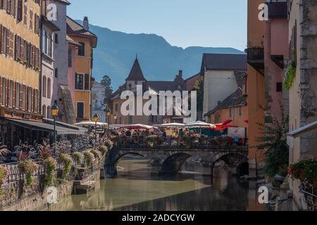 ANNECY, FRANCE - SEPTEMBER 13, 2019 : locals and tourists enjoy shopping in food market in Annecy city center. Stock Photo