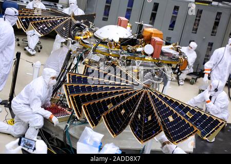 InSight Mars lander solar array test. Engineers and technicians testing the solar array for NASA's Insight Mars lander. They are performing an illumin Stock Photo