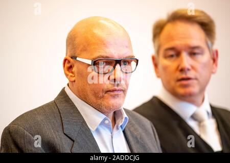 Detmold, Germany. 04th Dec, 2019. The defendant Rolf Herbrechtsmeier (l) and his defender Carsten Ernst stand side by side in the courtroom. The public prosecutor's office in Detmold accuses the accused of 'driving licence king' Herbrechtsmeier of 505 cases of fraud which allegedly led to a total loss of almost 650,000 euros. Credit: David Inderlied/dpa/Alamy Live News Stock Photo