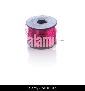 Coil of enamelled copper, which is copper wire coated with an insulator. This wire is often used to make coils and electromagnets, and is also known a Stock Photo