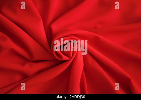 Red batiste made of cotton. sample of red soft fabric with pleats Stock Photo