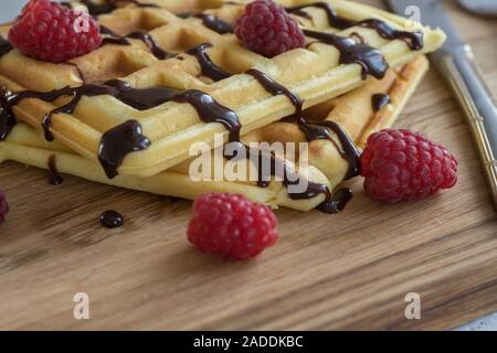 Viennese waffles with chocolate and berries on a wooden Board Stock Photo