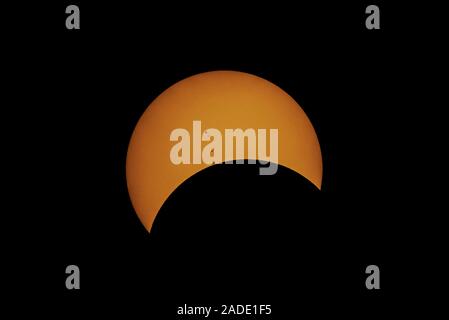 Total solar eclipse and sunspots. This partial phase of the eclipse is after totality, with a group (active region) of sunspots (AR2671) seen on the s Stock Photo