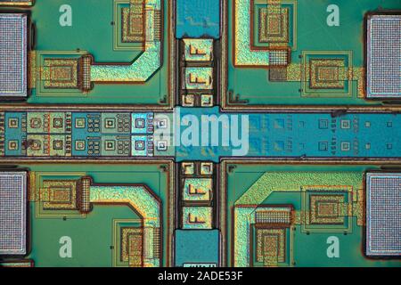 Microchip surface. Differential interference contrast (DIC) light micrograph of the surface of a silicon wafer etched with integrated circuits. Magnif Stock Photo